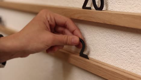 assembling a wall calendar with wooden shelves