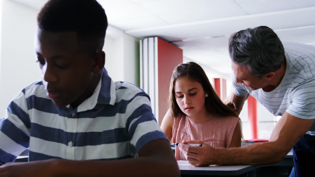 maestro ayudando a los estudiantes en el aula
