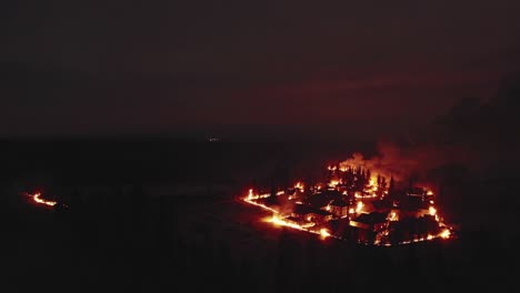 nighttime aerial view of wildfire burning village