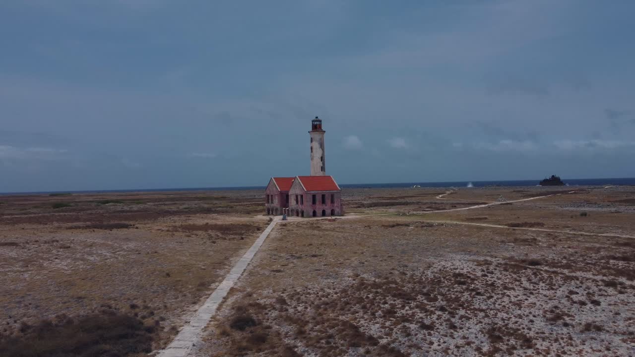 Establishing Landscape of Abandoned Colonial Light Tower building with ocean view