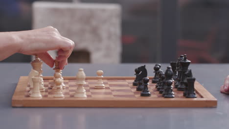 Side-view-of-a-chessboard-with-playing-people