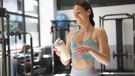 woman at the gym with a protein shake
