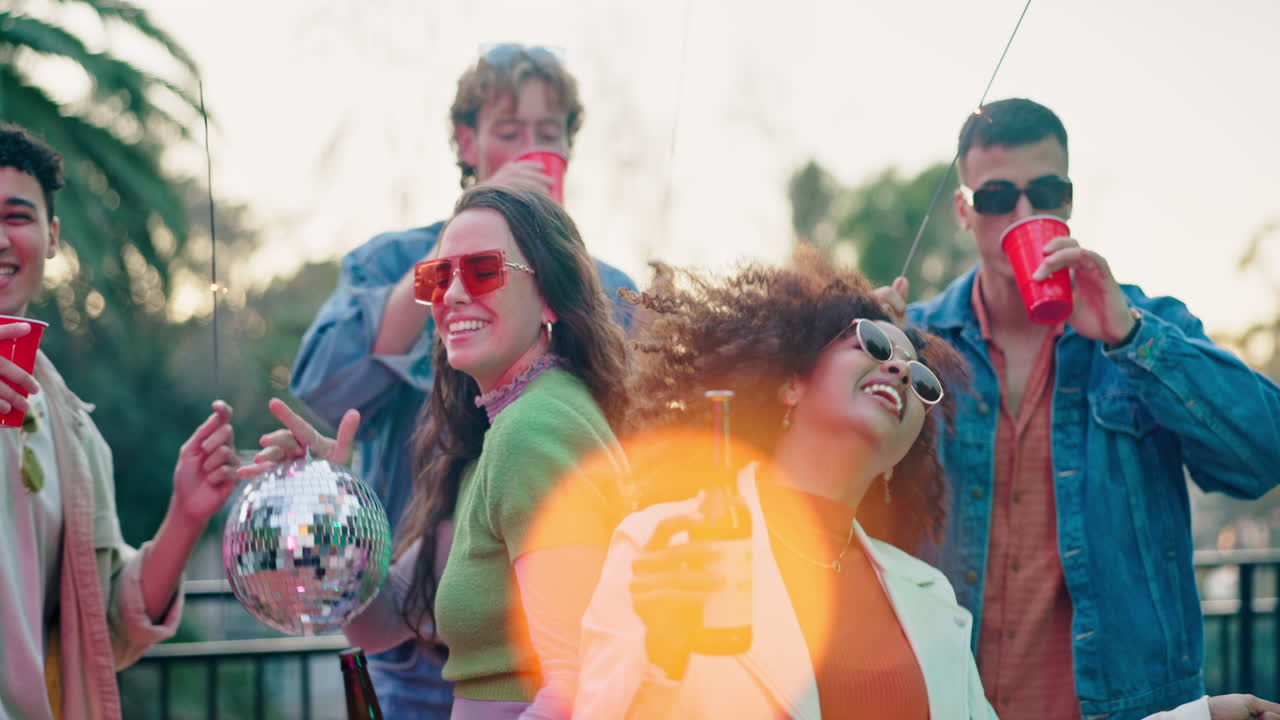 Group of friends celebrating with drinks and sparklers
