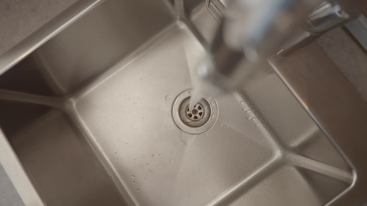 Water running into a stainless steel sink