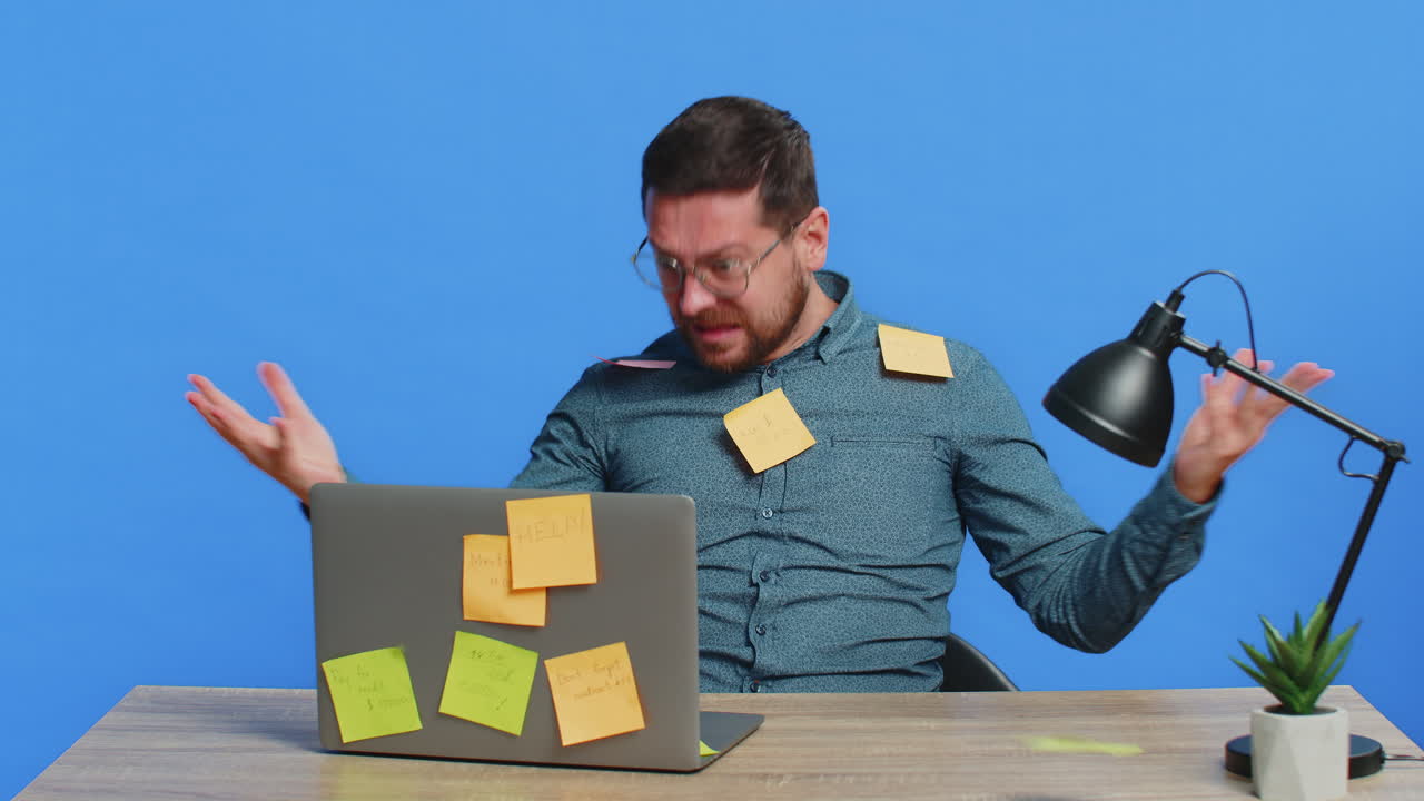 Nervous man with pasted sticker notes use laptop having concentration problem big routine work