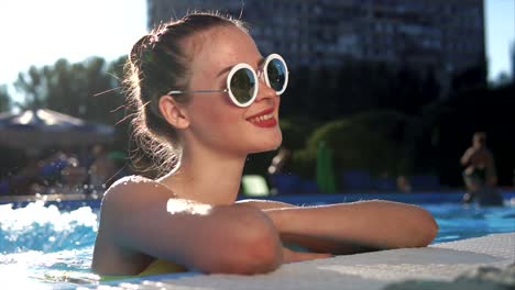 young woman relaxing by pool