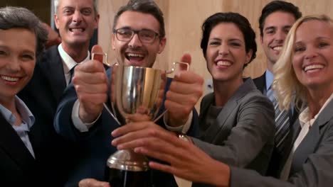 happy lawyers holding trophy