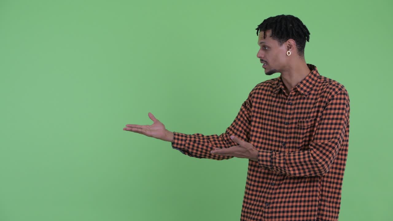 Happy young handsome African man with dreadlocks