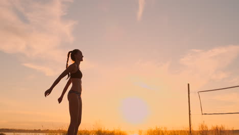 Young-girl-jump-serve-volleyball-on-the-beach-slow-motion