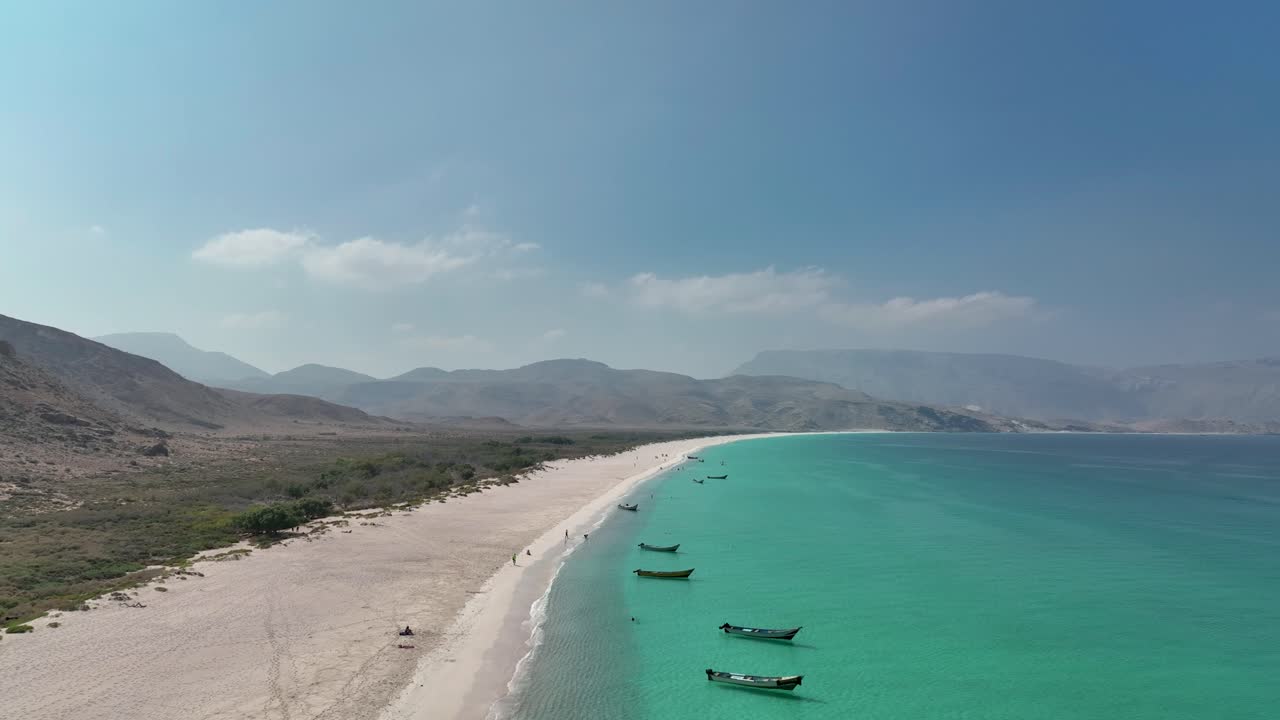 Astounding View Of White Sand And Azure Water Of Shoab Beach With Mountains In Background At Socotra Island In Yemen
