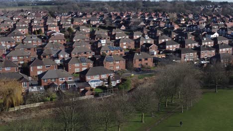 Suburban-Neighbourhood-Merseyside-residential-homes-rooftops-real-estate-property-aerial-low-orbit-slow-right-view