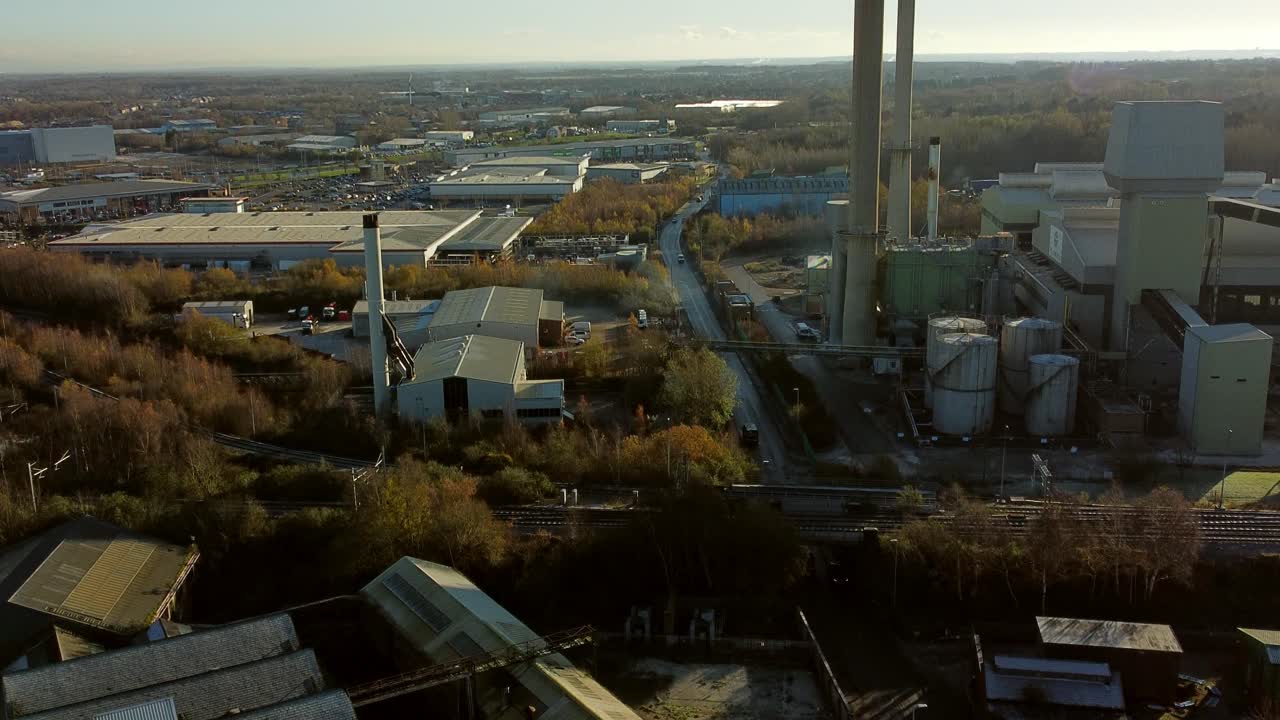Pilkington glass factory warehouse buildings aerial view tilt up over industrial town manufacturing facility