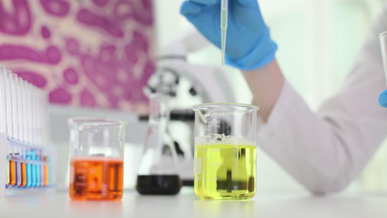 Scientist conducting an experiment with liquids in a laboratory