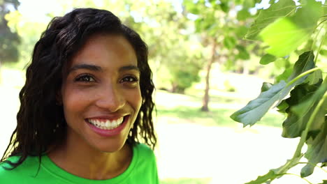 Happy-environmental-activist-looking-at-leaves-through-magnifying-glass-