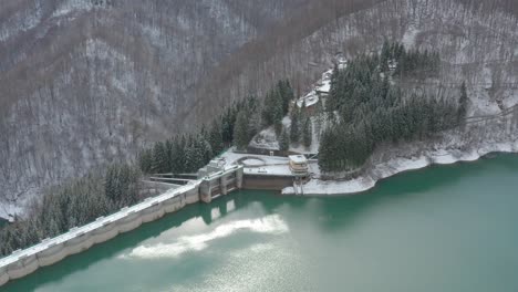 aerial view of a lake surrounded by the snow