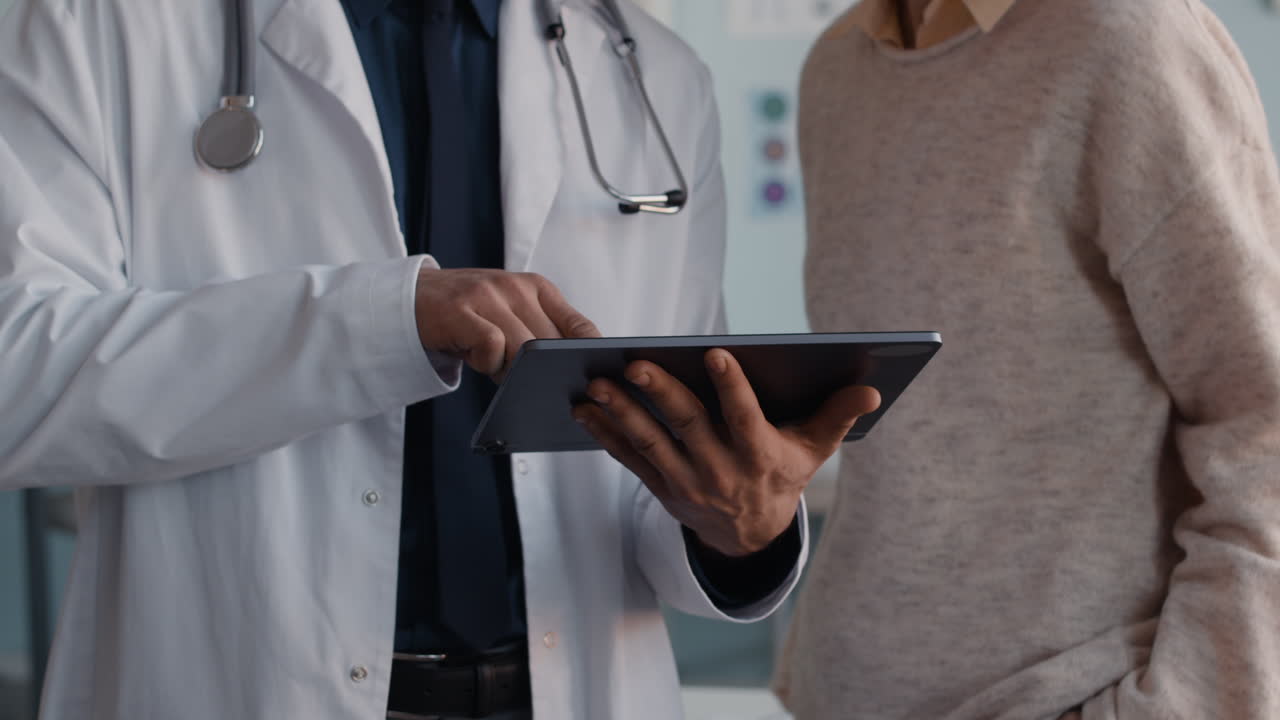 Doctor consulting with patient using tablet