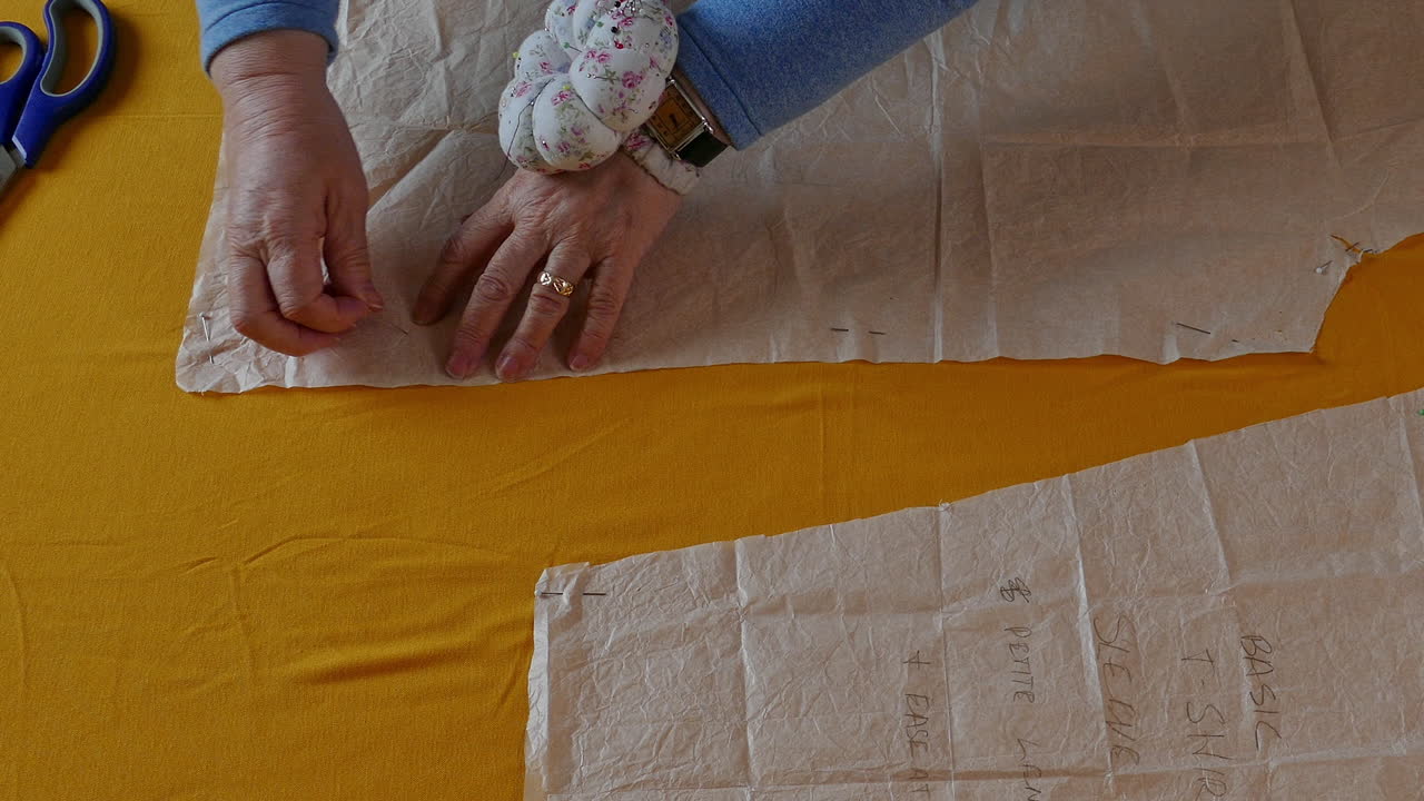 Pinning out a pattern for a T shirt ready to be sewn