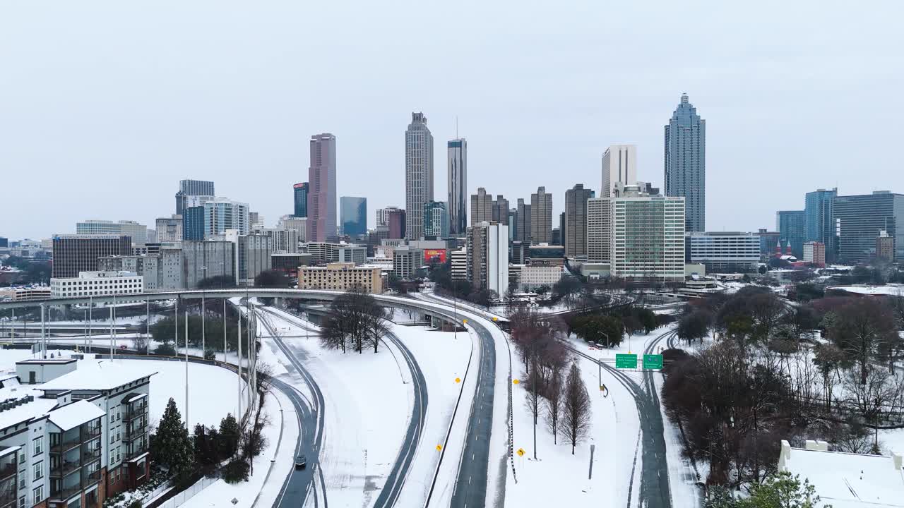Aerial push in on snow covered Downtown Atlanta Georgia from the Jackson Street Bridge on January 10th 2025.