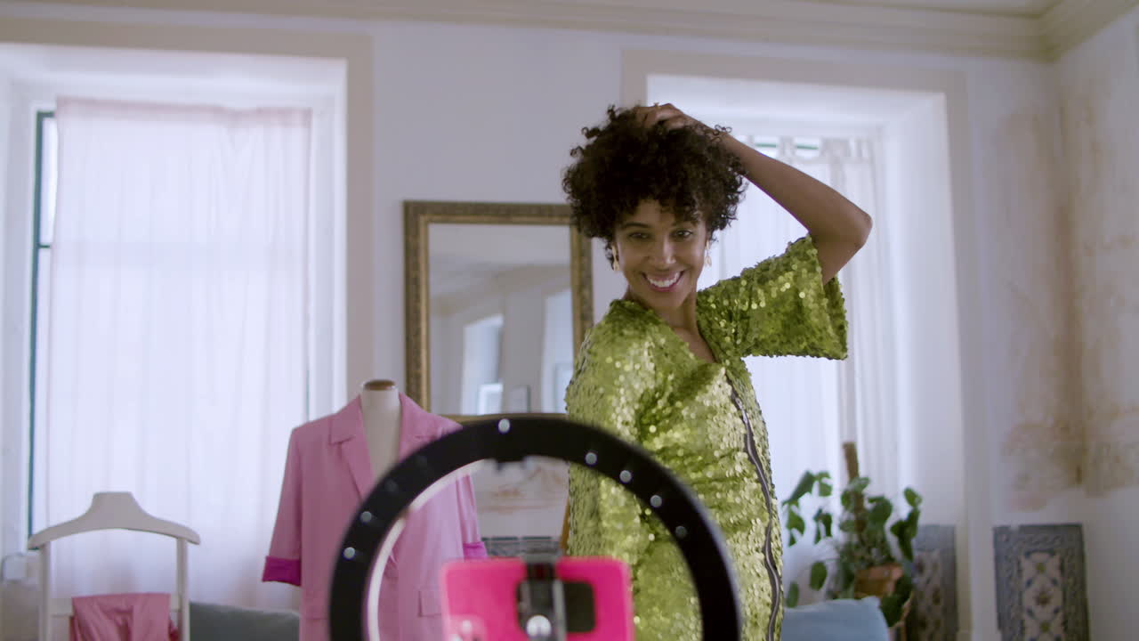 Pretty short-haired Black woman dancing in front of camera