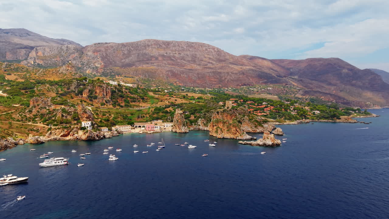 Many boats in the rocky coast of Scopello, Sicily. Aerial