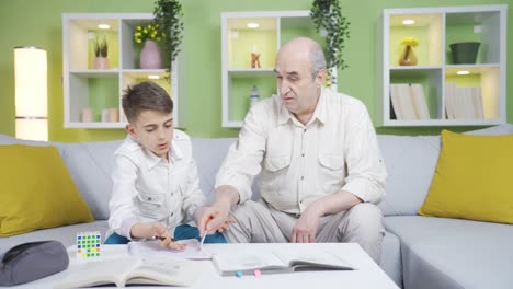 grandpa helping his grandson with his homework.