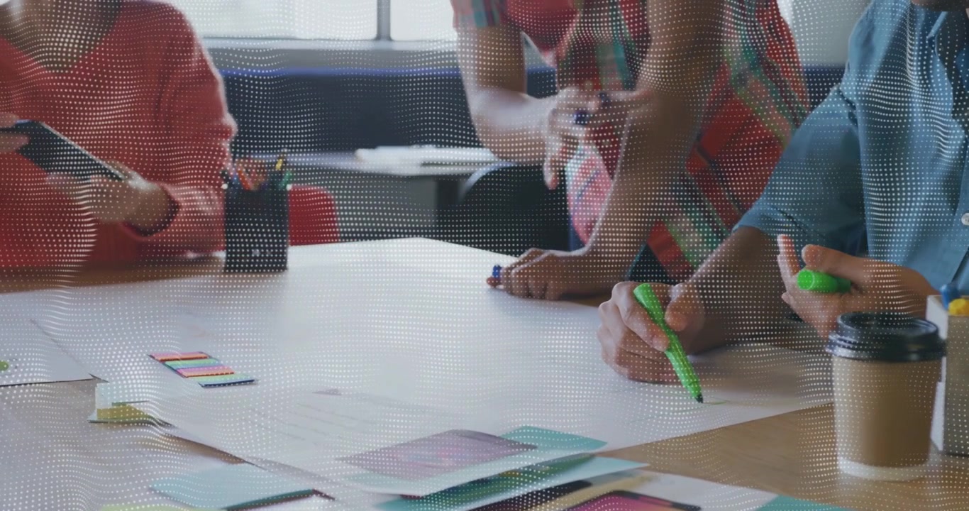 Team picking green marker and sketching while pointing and arranging swatches for design project