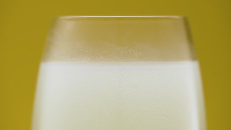 cold white liquid in the glass, frosted glass