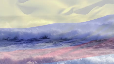 composición digital de ondear la bandera de colombia contra las olas en el mar