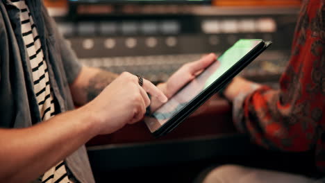 person using tablet in recording studio