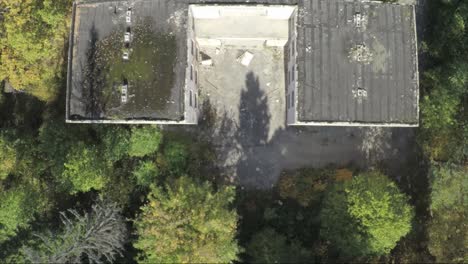 aerial view of an abandoned building surrounded by trees