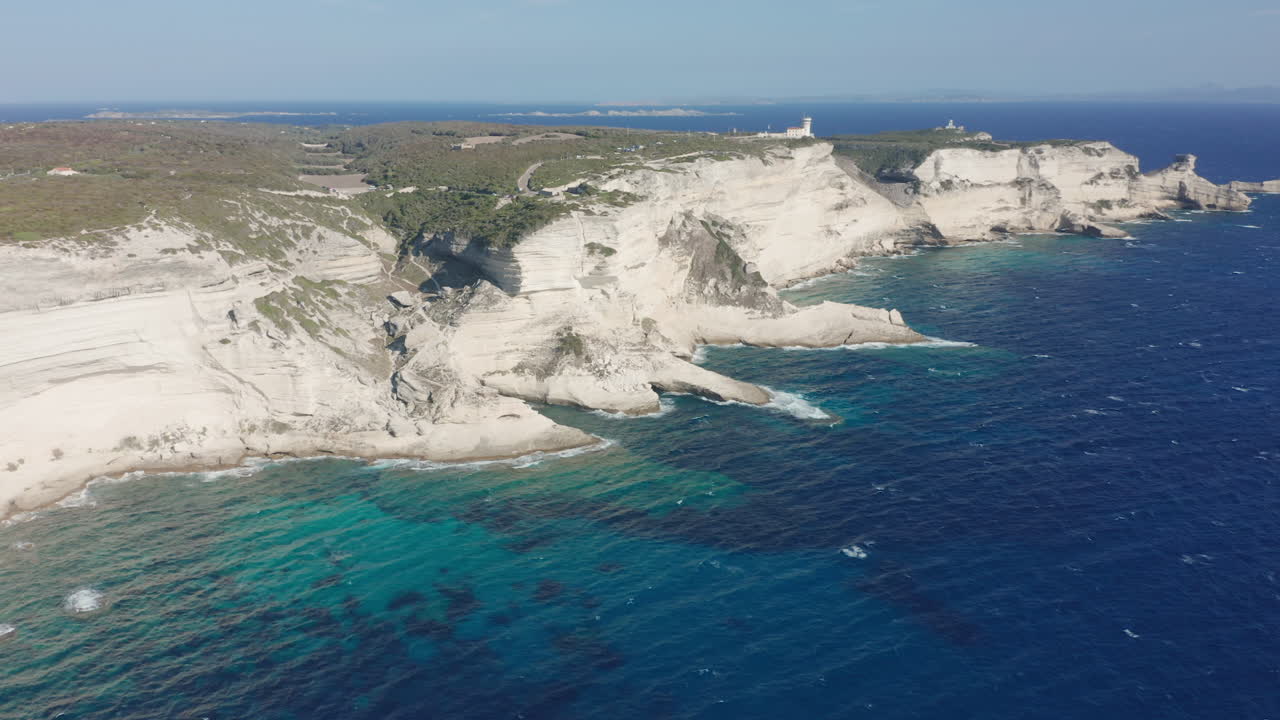 Bonifacio Corsica aerial drone shot coastline cliffs lighthouse rugged limestone the turquoise Mediterranean Sea iconic French island landscape