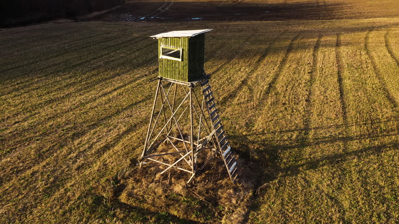 Wooden hunting tower in aerial parallax shot
