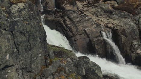 powerful waterfall cascading down rocky mountainside