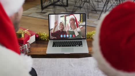 Caucasian-couple-having-a-christmas-video-call-with-family