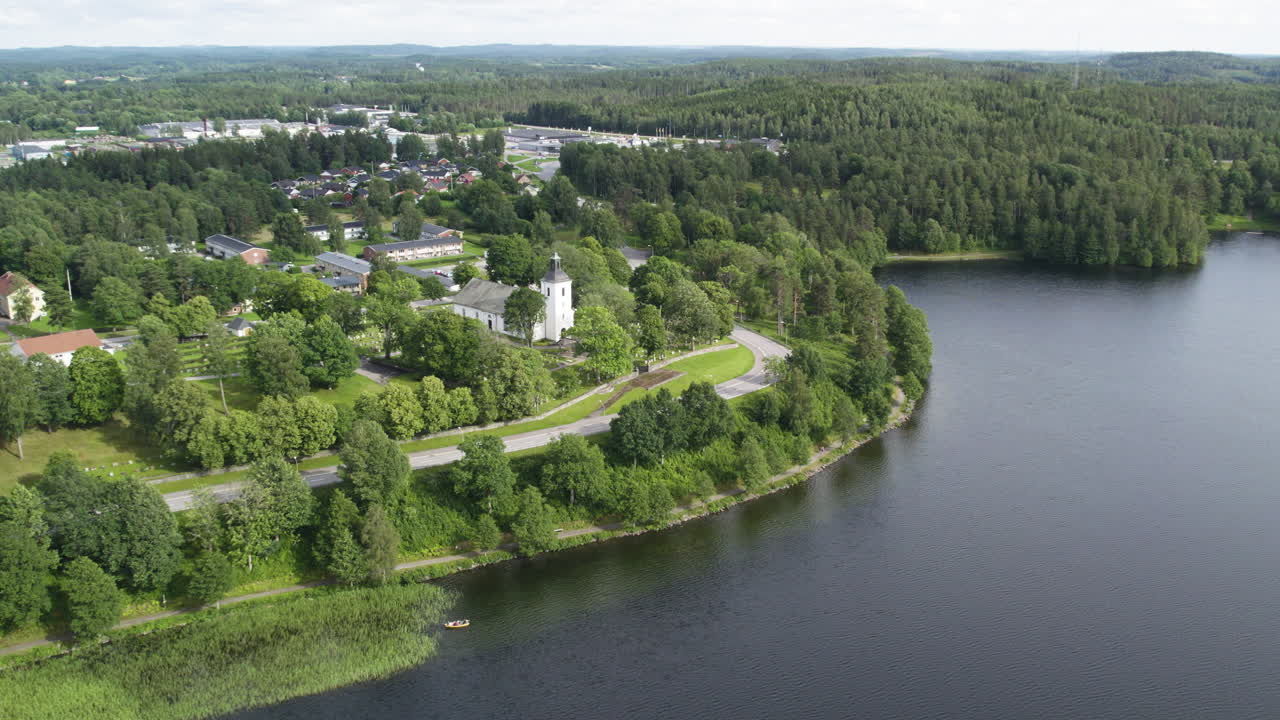 A scenic aerial view of Dals-Eds Church by Lake Lilla Le in Dalsland, Sweden