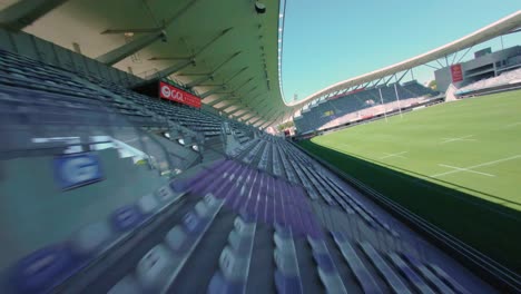 cinematic fpv shot exploring the empty seating area in stade de rugby ggl de montpellier