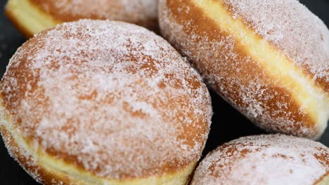 fresh made berliner doughnuts rotating on a plate (seamless loopable)