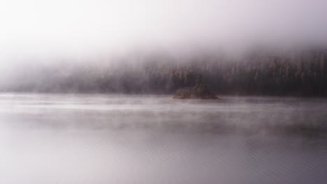 foggy dramatic scene looking across swan lake in montana