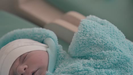 cute little baby in warm fluffy suit lies on changing table