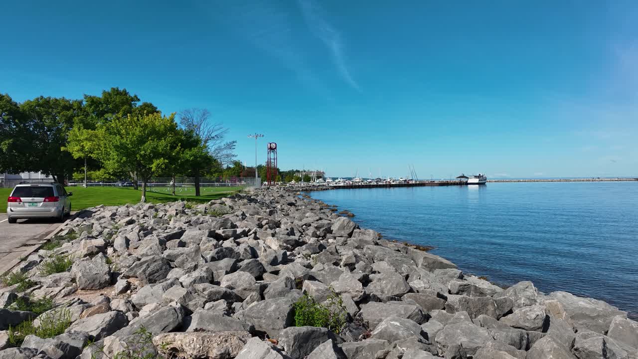 Town landmark in the distance from a nearby rocky shore, pushing toward the tower