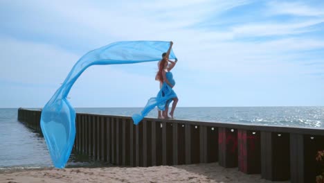 couple kissing on sea pier. love couple on sea vacations. pregnant couple