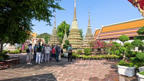 visitors explore wat pho's stunning architecture