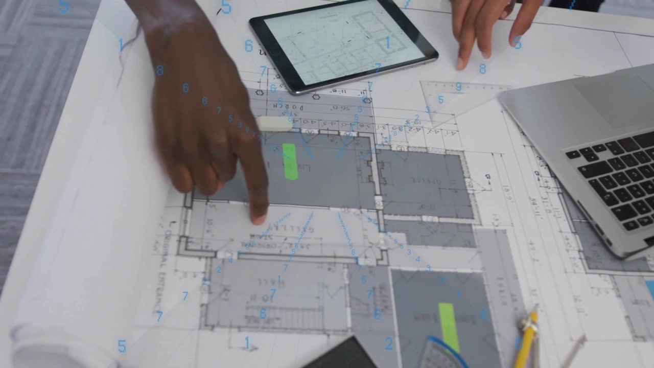 Architects Reviewing Building Blueprints and Digital Tablet in Office