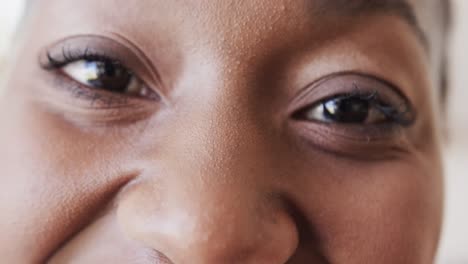 portrait close up of eyes of happy african american woman smiling, in slow motion, copy space