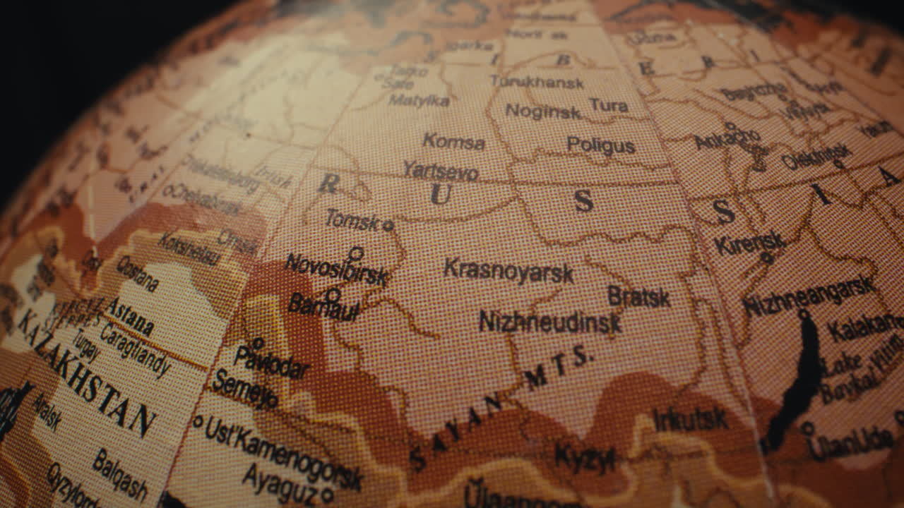 Close-up view of a world globe, focusing on the Asia-Europe region