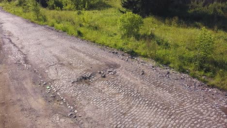 damaged cobblestone road in rural area