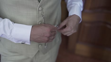 close up of hands closing a pocket watch, conveying anticipation and significance