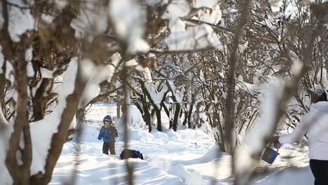 Mother walking with son. Small child and mother in the winter outside in warm clothes