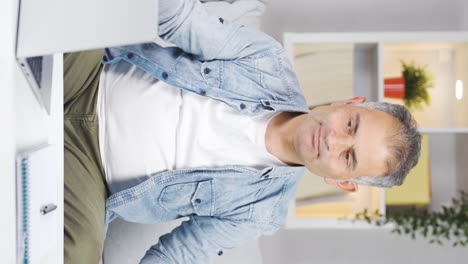 Vertical-video-of-Man-combing-his-hair.