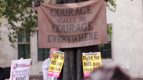 nhs london protest with statue